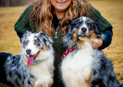 Two Australian Shepherds posing with their dog mom for a photo in Hartford, CT