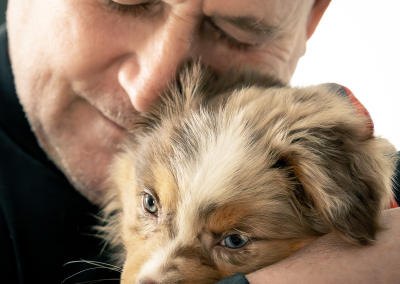 Man hugs his new puppy Boston MA